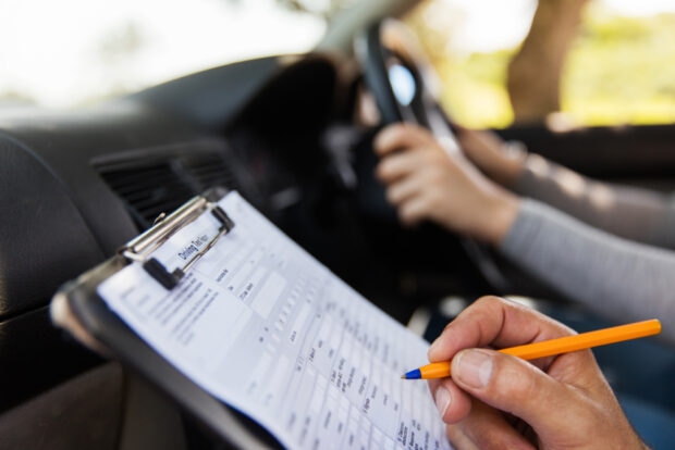 What is causing the long driving test waiting times